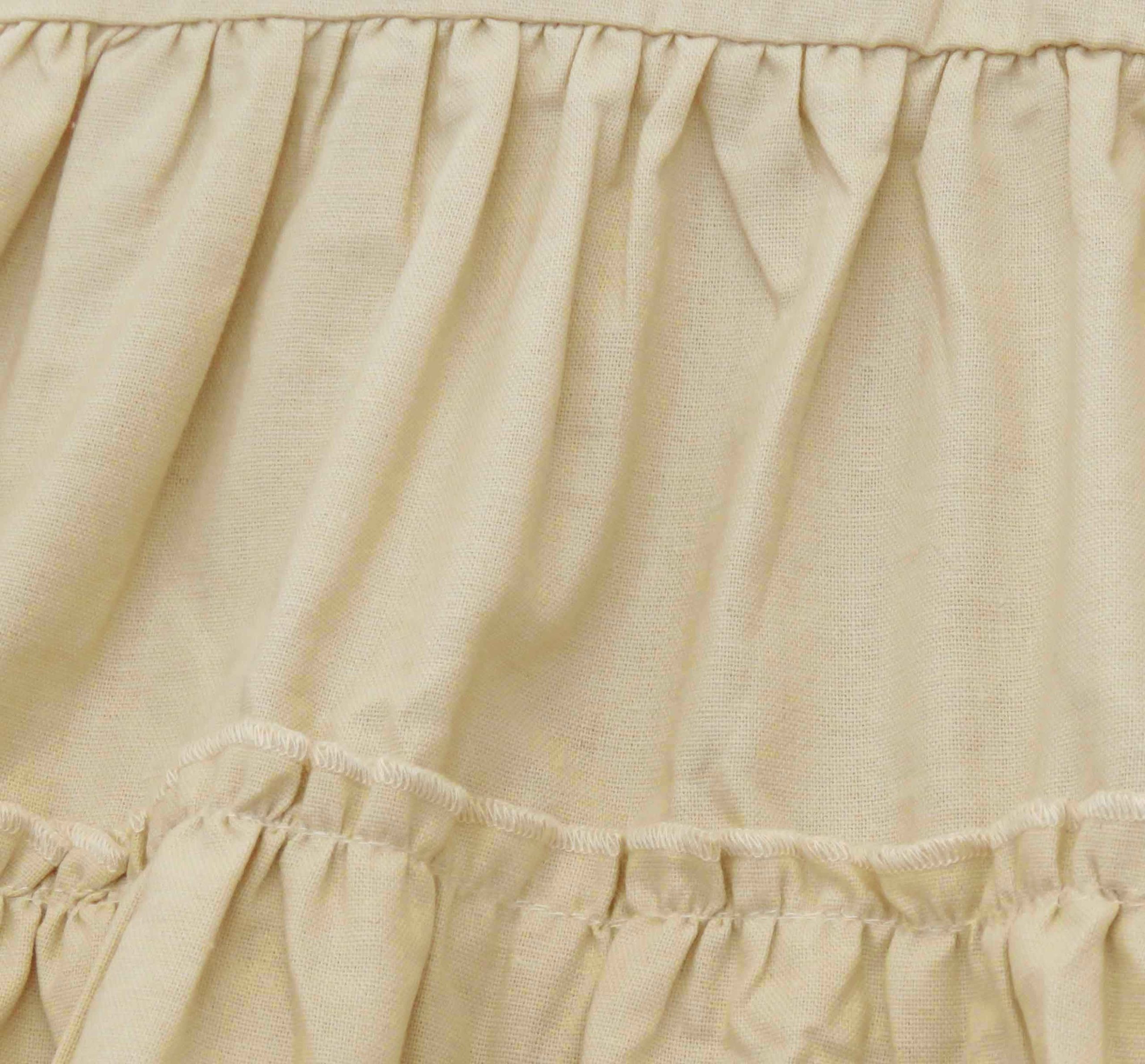 kids on trend cream/fawn coloured linen dress - detail of ruffled skirt