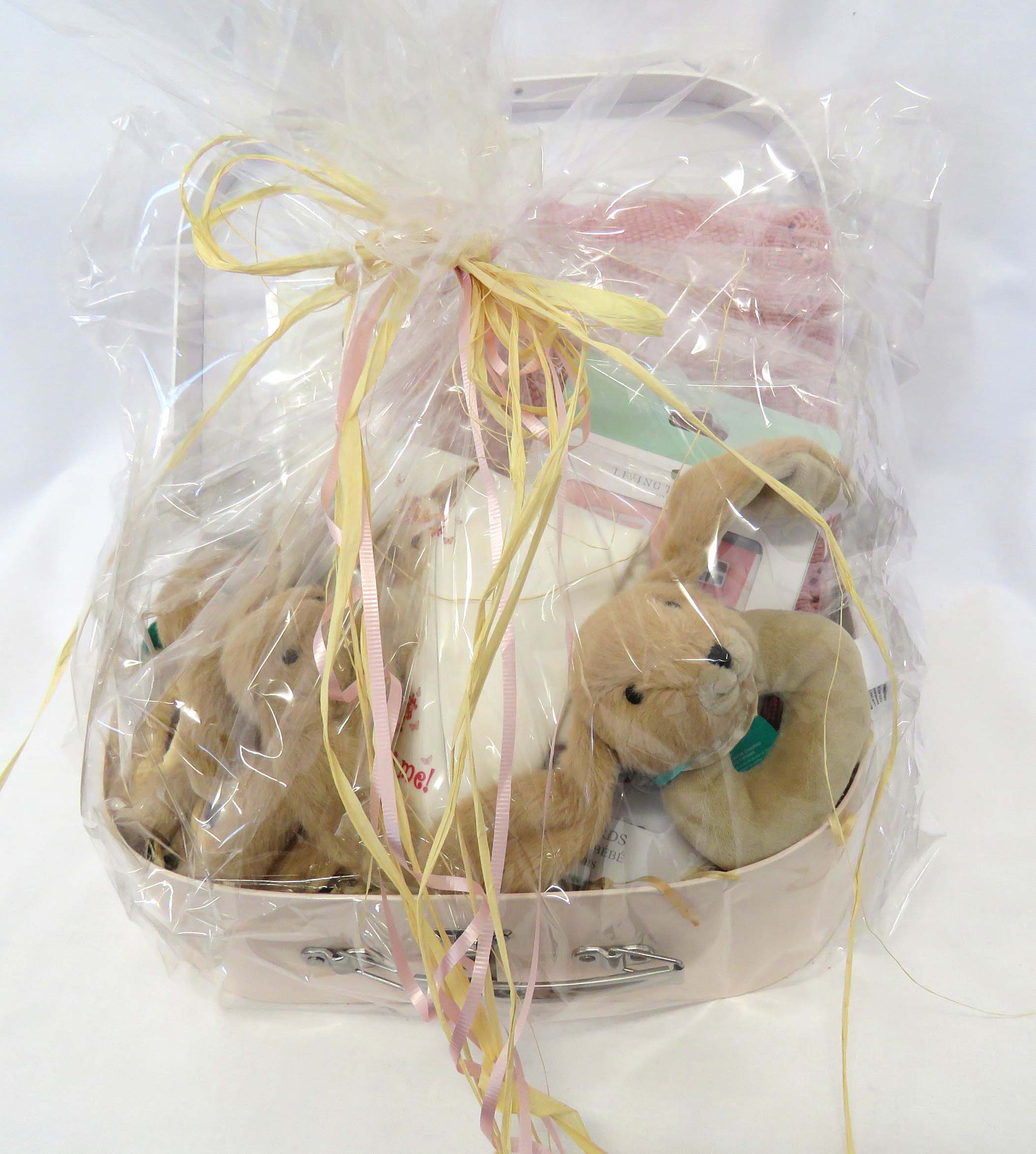large hamper for babies wrapped in cellophane and tied with raffia ribbon