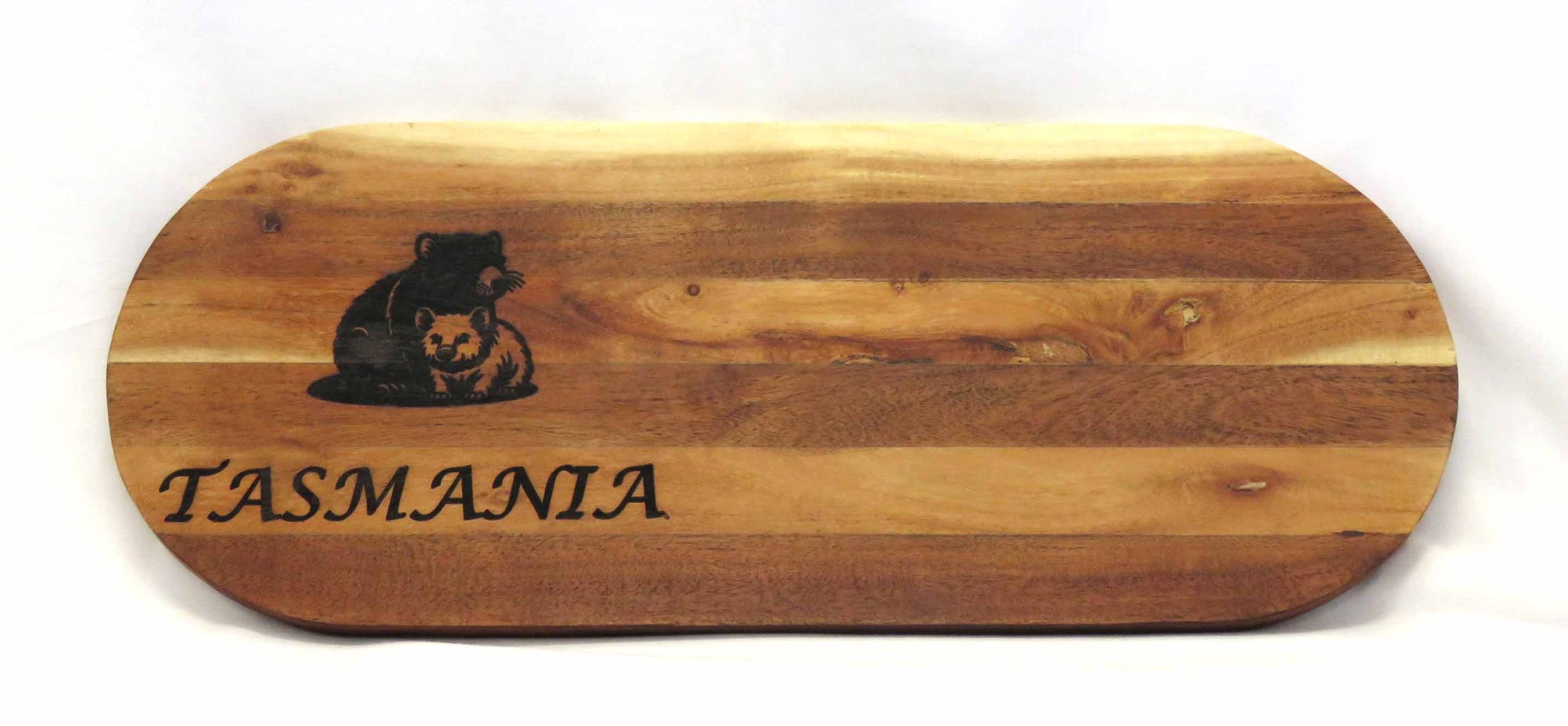 laser printed tassie devil and wombat on a long platter board made of strips of light and dark acacia wood