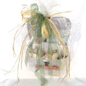 Medium sized baby hamper wrapped in cellophane with raffia and green ribbon