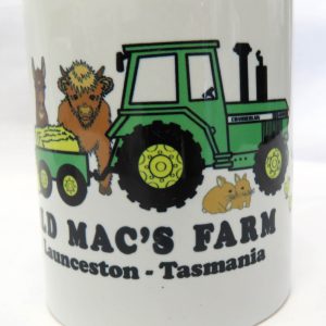old macs coffee mug with cartoon style green tractor and animals front view