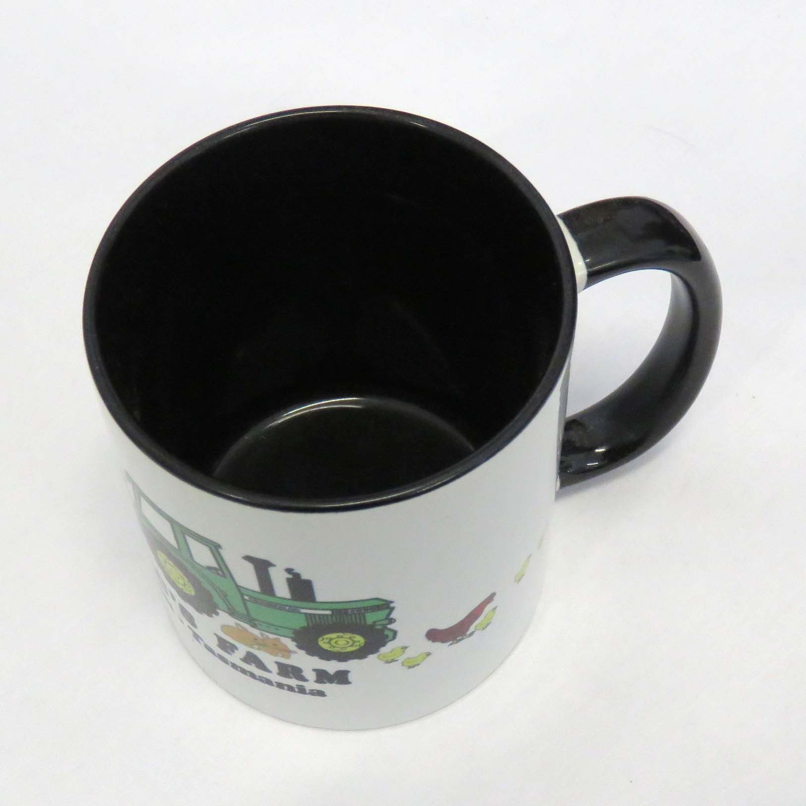 old macs coffee mug in black with cartoon style green tractor and animals