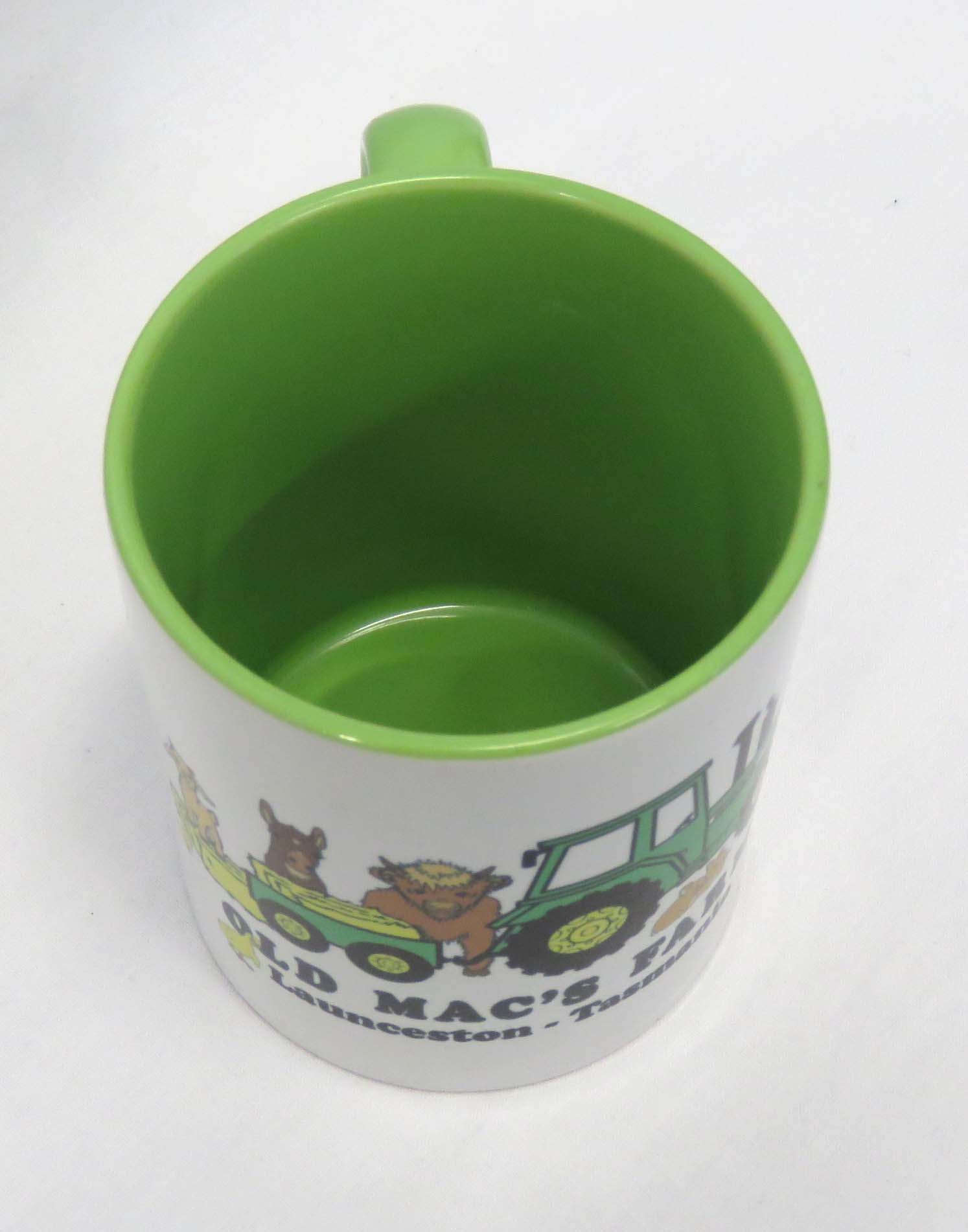 old macs coffee mug in green with cartoon style green tractor and animals