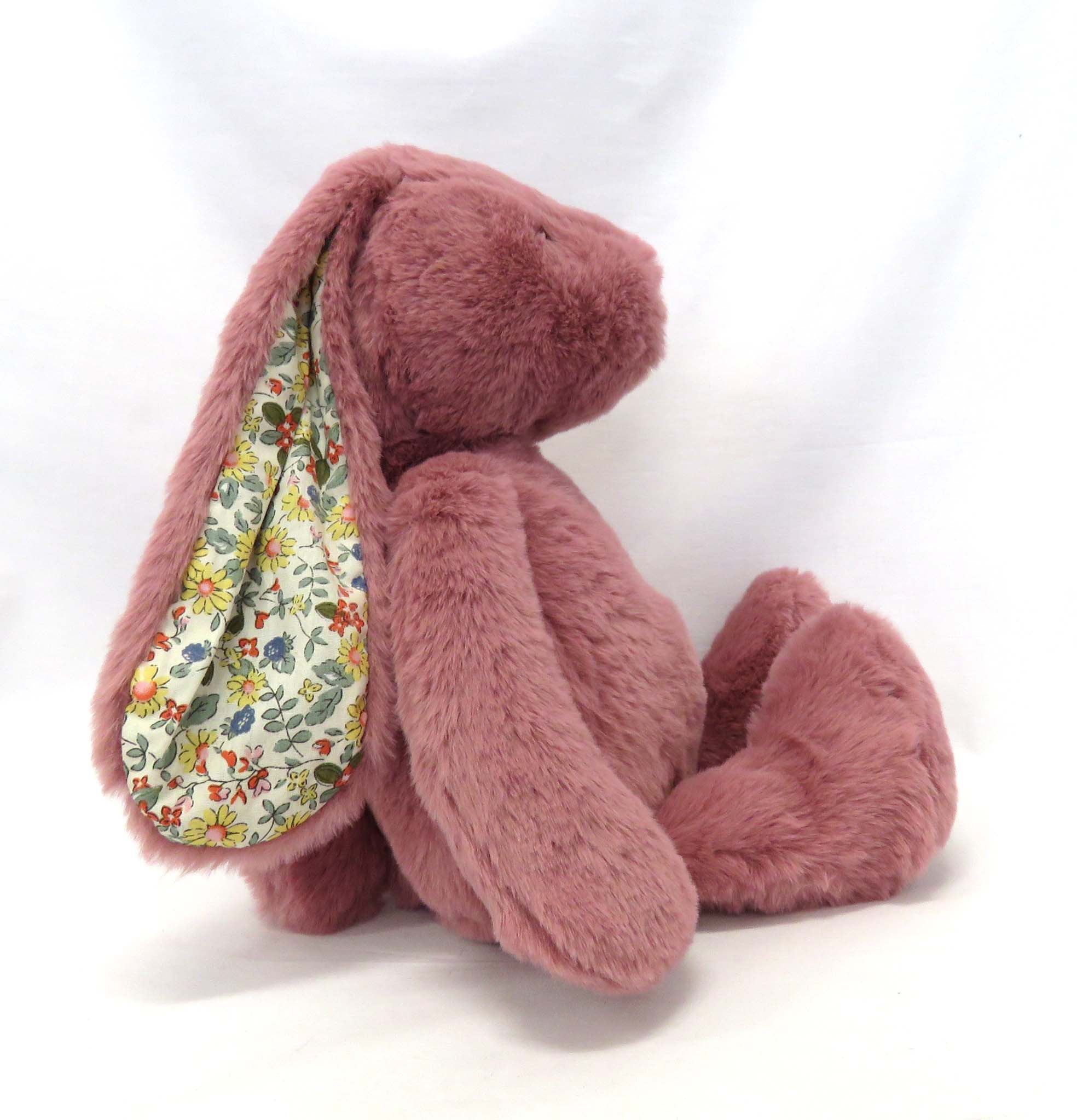 raspberry pink plush bunny with floral ears side view