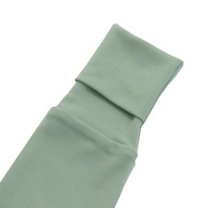 kids on trend baby romper in a soft sea green close up view of sleeve