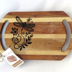 laser printed dragonfly on a platter board made of strips of ight and dark acacia wood