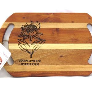 laser printed flowers on a platter board made of strips of light and dark acacia wood text reads tasmanian waratah
